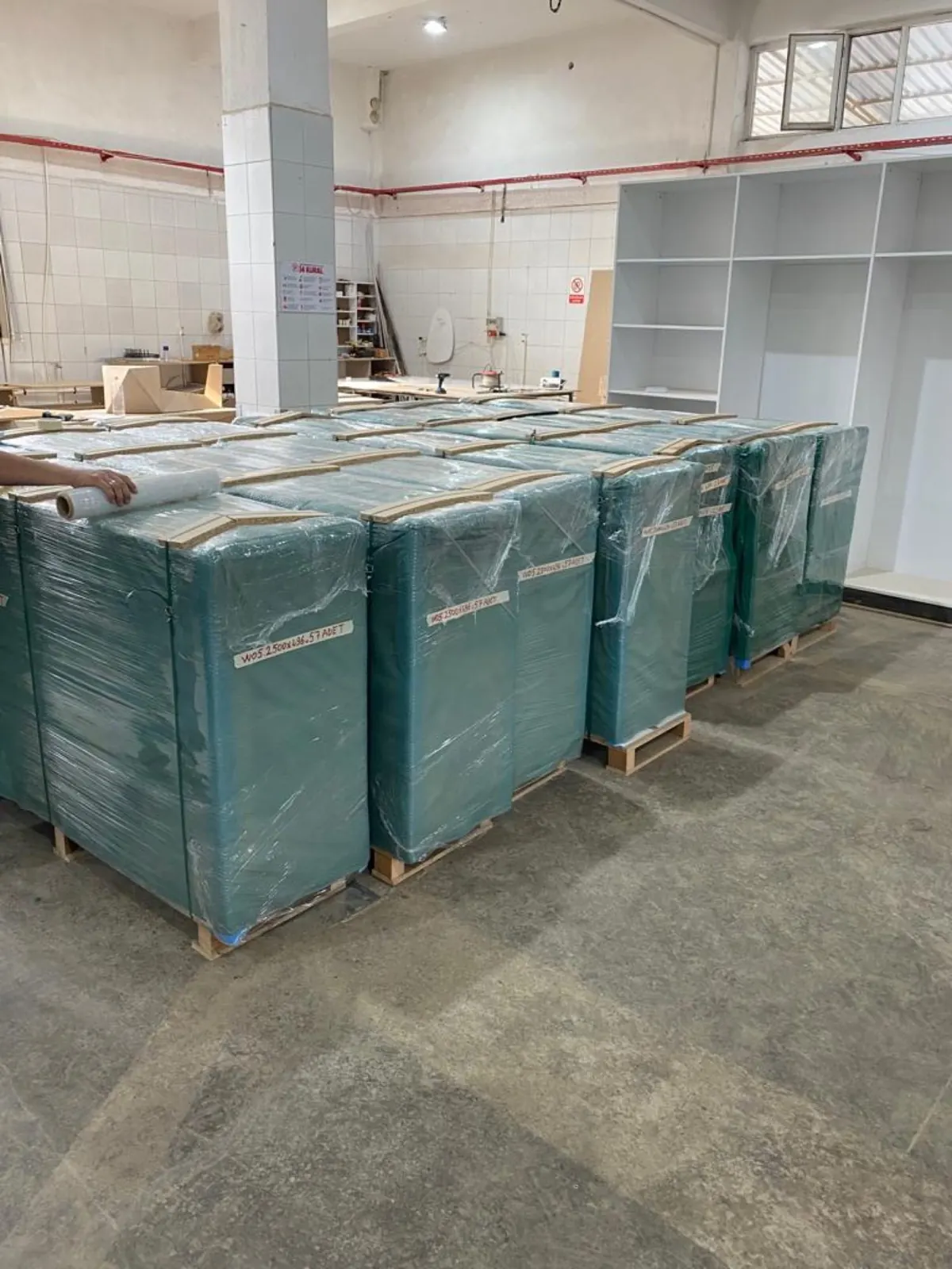 Crates wrapped and labelled by room on pallets, ready to load