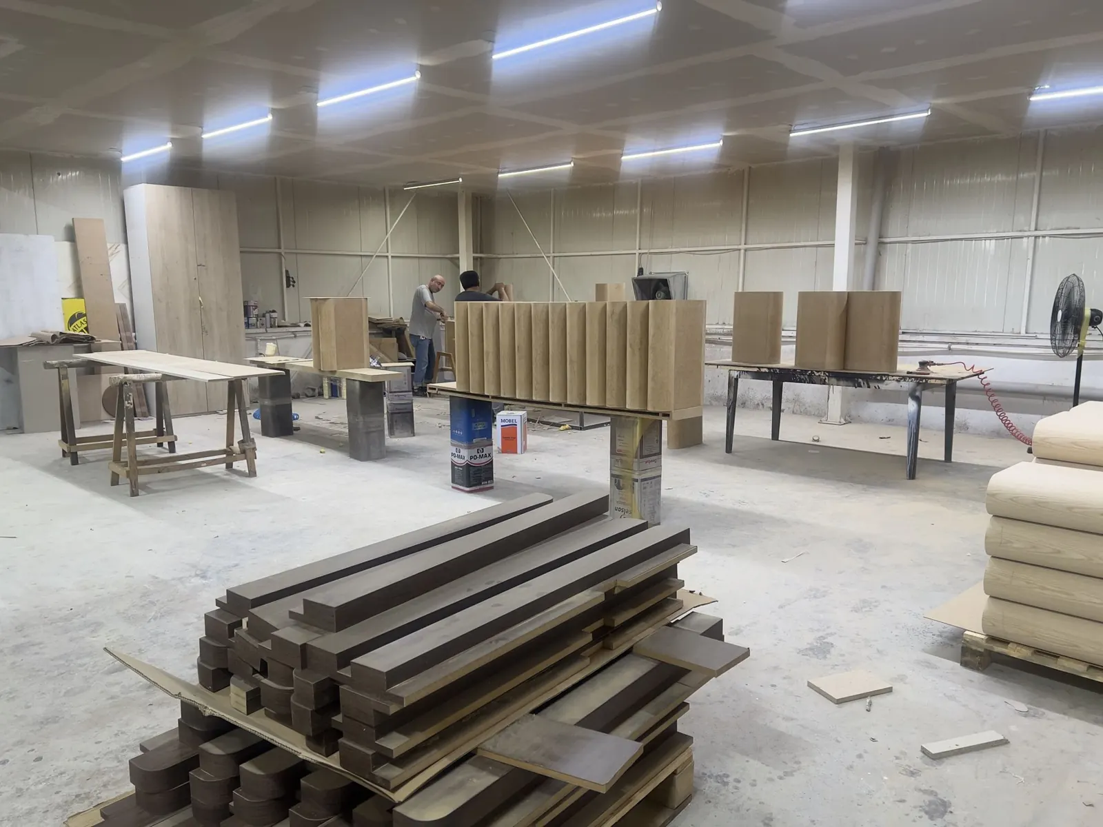 Workshop floor with timber stock cut for the fluted fronts