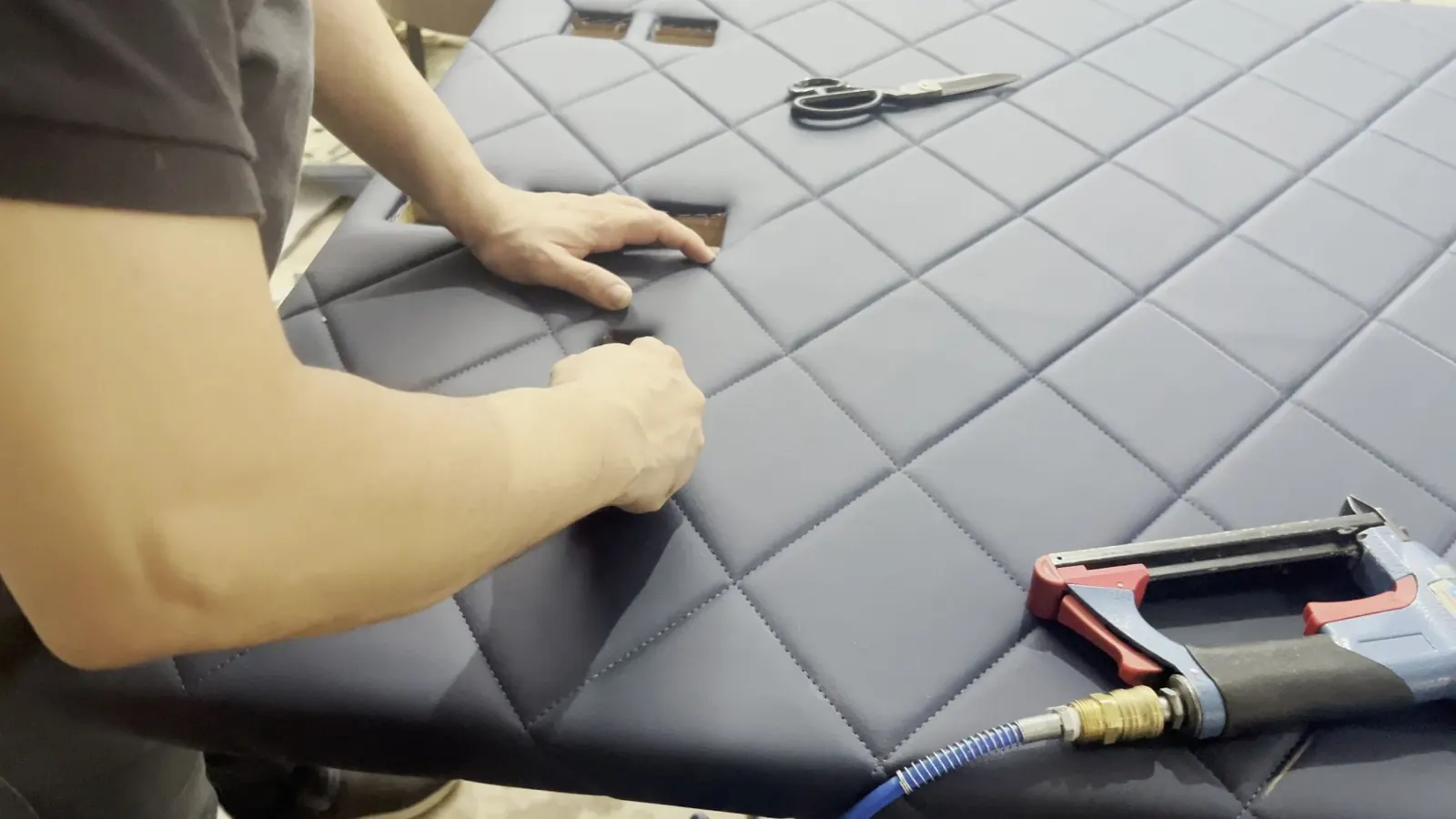 Quilted headboard fabric being fitted by hand